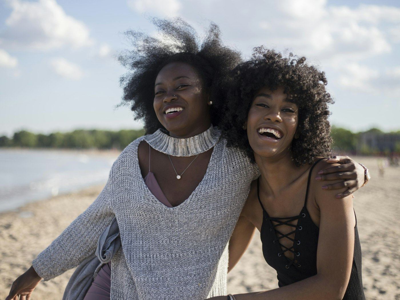 Two women laughing together outdoors