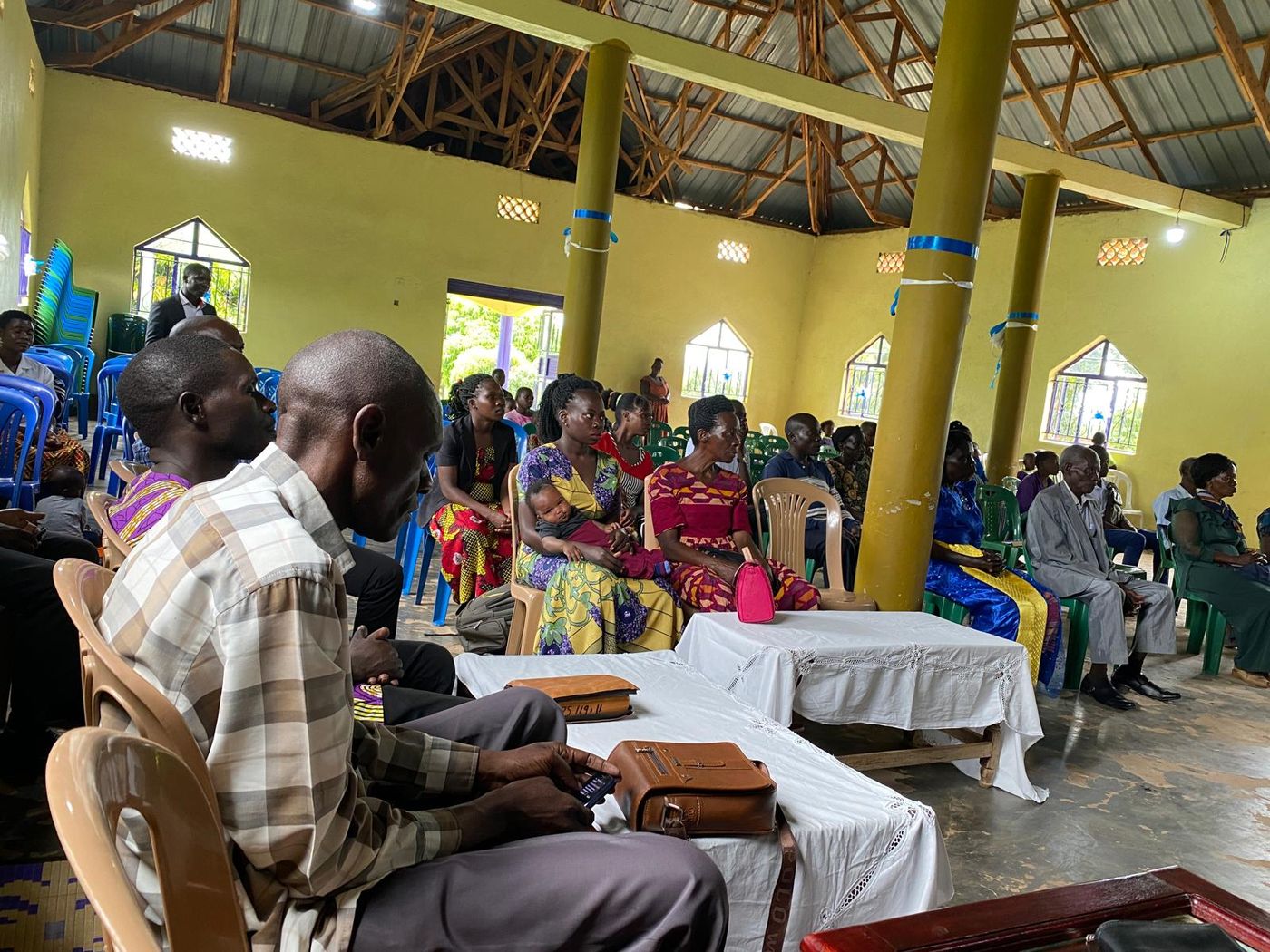 A congregation seated together through a service, filling the room