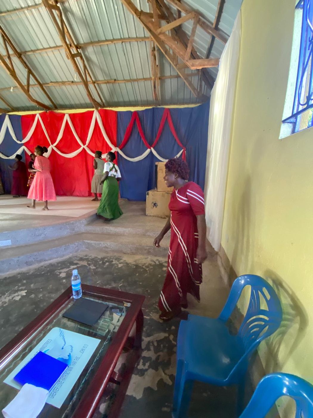Women standing together in fellowship after a service, talking and laughing